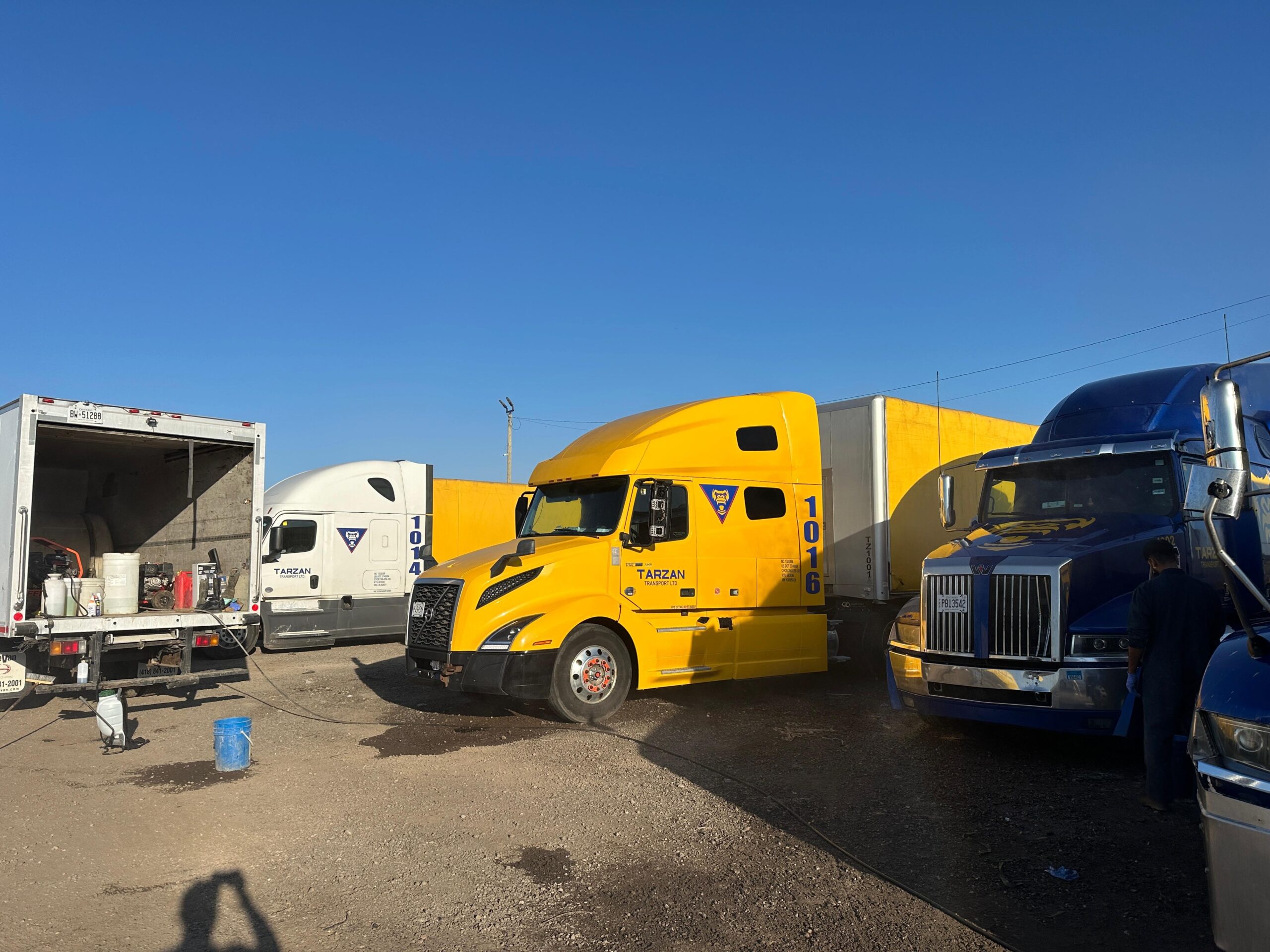 Image Showing worker washing Trucks with power washing